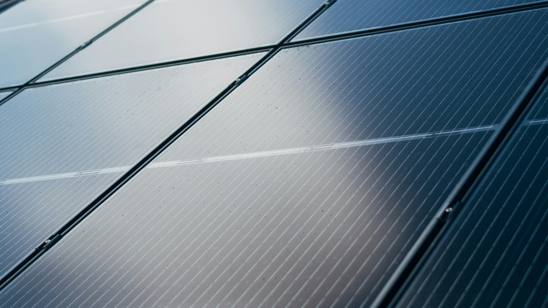 Aerial view of a utility-scale solar farm at sunset